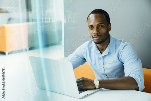 Business man working on laptop computer in modern office space