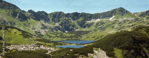 Panorama on Tatras mountains, Valley of five ponds. View on mountains and two lakes. Trail to see eye from the mountain hostel in five ponds.  Five breathtaking mountain lakes in the High Tatras. photo