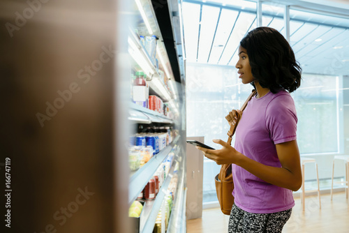 Photography Woman in convenience store on cell phone