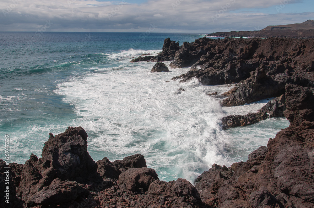 Rocky bay with fringing oceanic waves, Los Hervideros, Lanzarote, Canary Islands