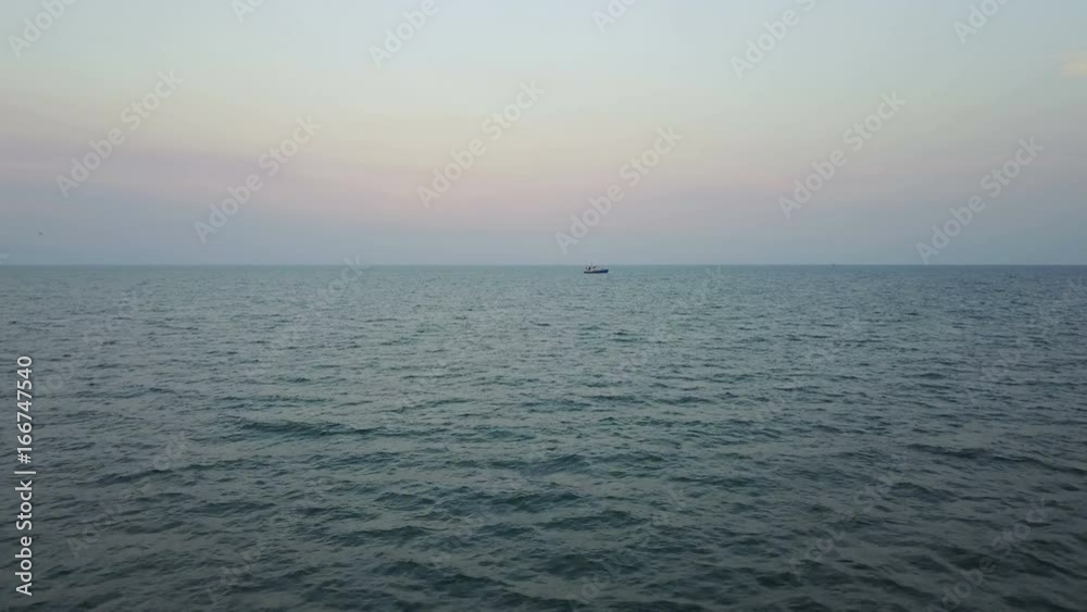 Fishing boat in the Azov Sea at sunset. aerial survey Fishing boat in the Azov Sea at sunset. aerial survey
