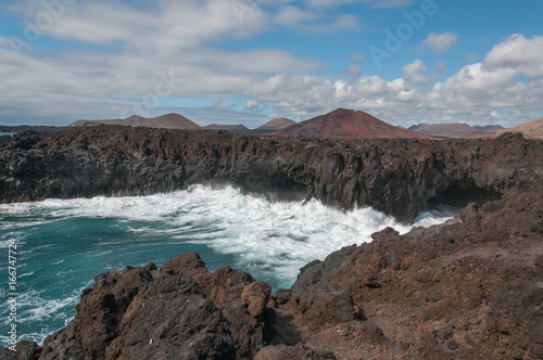 Los Hervideros rocky bay with small volcanoes  Lanzarote  Canary Islands
