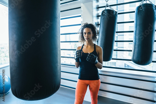 Portrait of fit woman in boxing gym