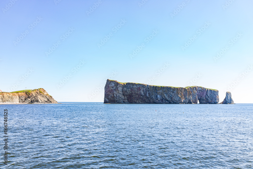 Famous Rocher Perce rock in Gaspe Peninsula, Quebec, Gaspesie region with house on cliff