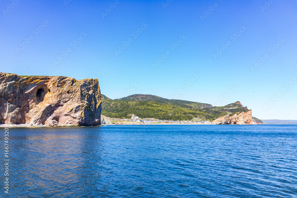 Panorama cityscape of Perce in Gaspe Peninsula, Quebec, Gaspesie region with cliffs in morning and Rocher Perce side view