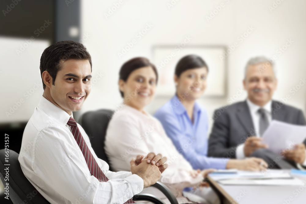 Happy business people smiling in meeting room Happy business people smiling in meeting room