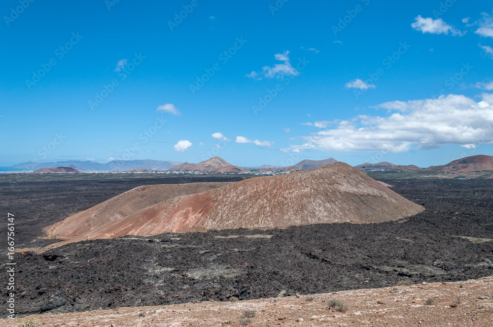 Volcanic cinder cone surrounded by ancient basaltic lava flows, Lanzarote, Canary Islands