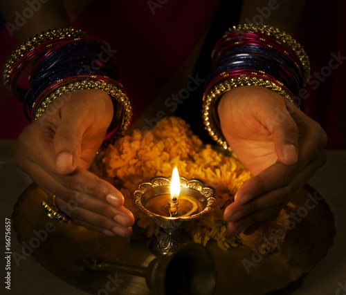 Hands cupped around a diya  photo