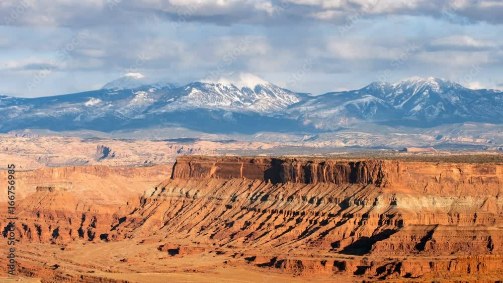 Time lapse of desert mesa and snow covered mountains in Utah