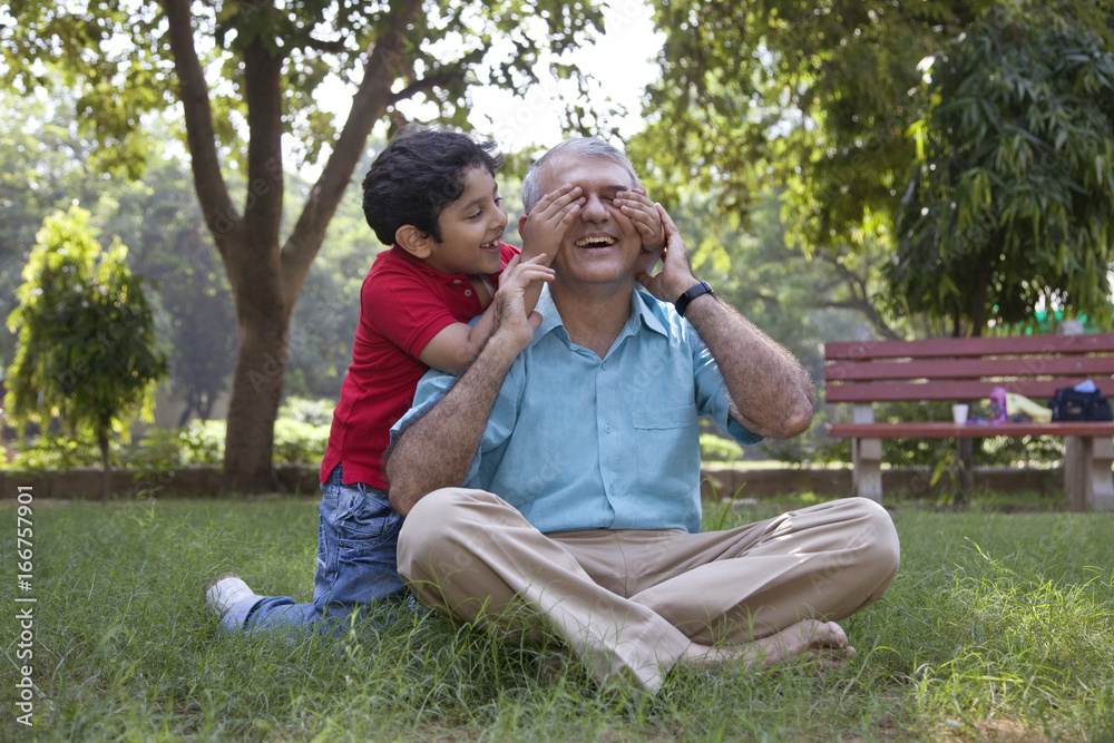Grandson covering grandfathers eyes Grandson covering grandfathers eyes
