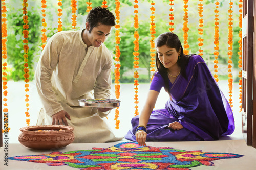 Couple making a rangoli  photo