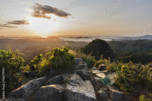 Top of the Castle Rock, Coromandel New Zealand. view from the top, sunset, forest hills, seashore view, ocean and islands. photo