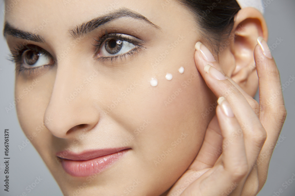 Beautiful woman with cream on her face Beautiful woman with cream on her face