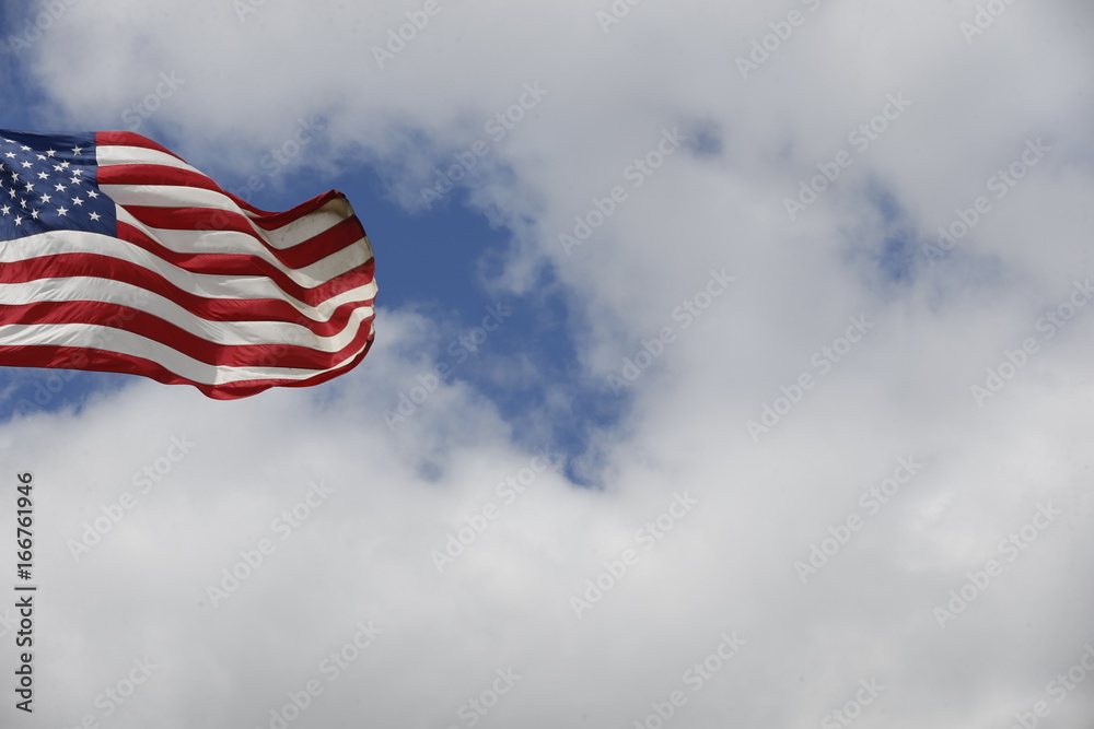 American flag flying under the blue sky and clouds Stock Photo | Adobe ...