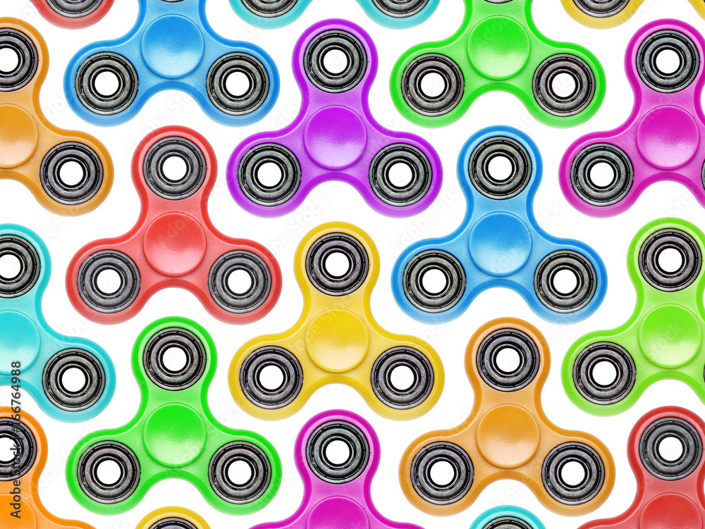 Background of colorful fidget spinners. Stress relieving toy isolated on white background
