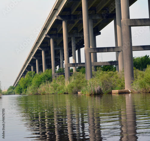 Bridge Reflection/Reflection of pillared bridge off a waterway, taken from below