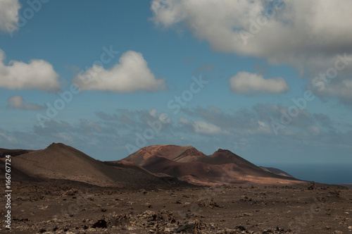 Ancient volcanoes in front of ocean  Lanzarote  Canary Islands