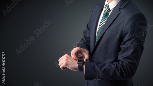 Man in suit wearing smartwatch.