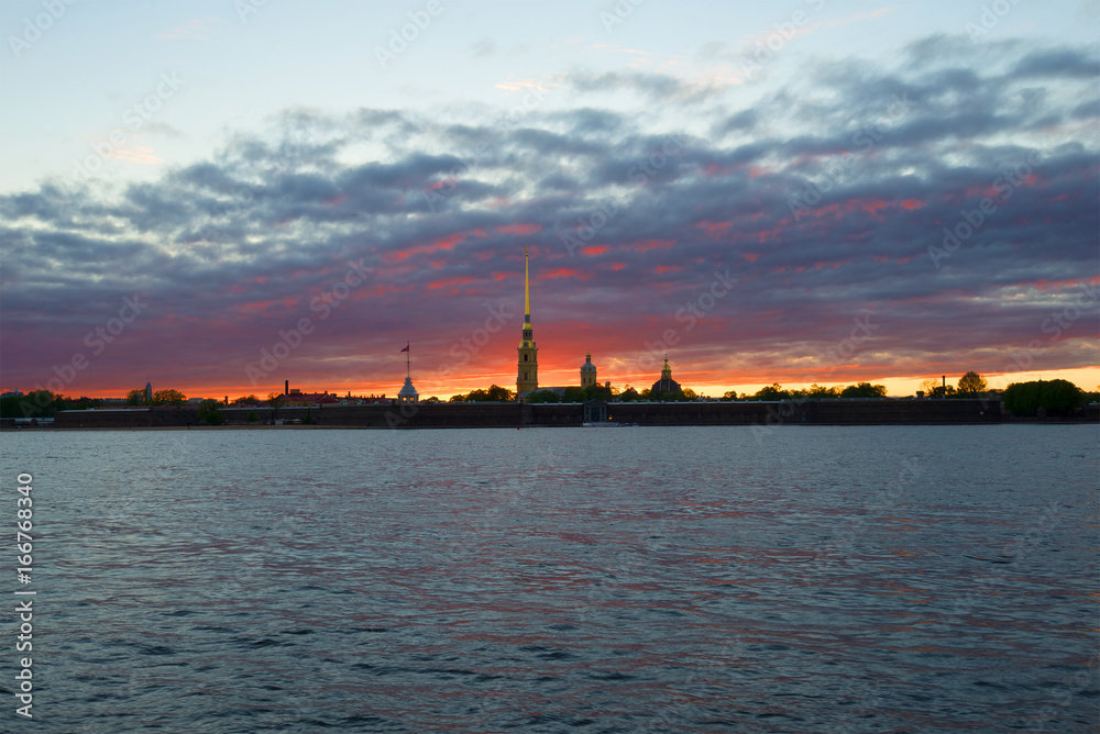 Panorama of the Peter and Paul fortress against the backdrop of a gloomy sunset. Saint-Petersburg, Russia