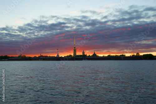 Panorama of the Peter and Paul fortress against the backdrop of a gloomy sunset. Saint-Petersburg, Russia