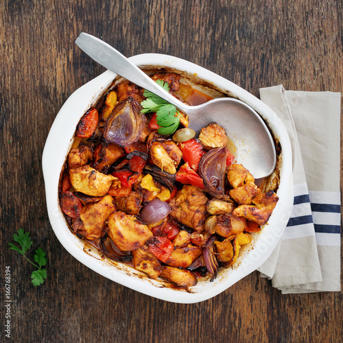 Baked chicken breast with vegetables on wooden table photo