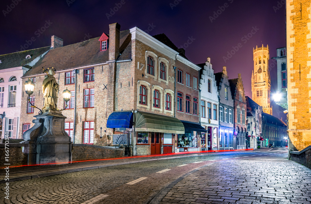 View from the Rozenhoedkaai in Brugge with the Perez de Malvenda house and Belfort van Brugge in the background at night.
