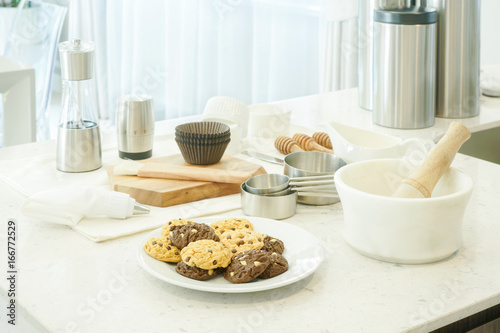 Bakery tools, ingredients and cookies on counter top in kitchen