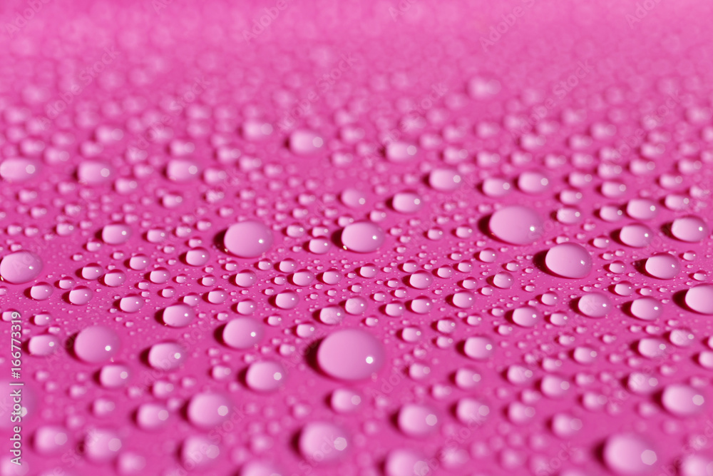 Background with water drops on fuchsia surface Background with water drops on fuchsia surface