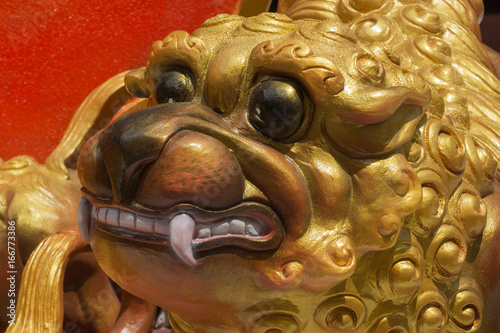 Close up of stone lion Chinese doll. © noppharat