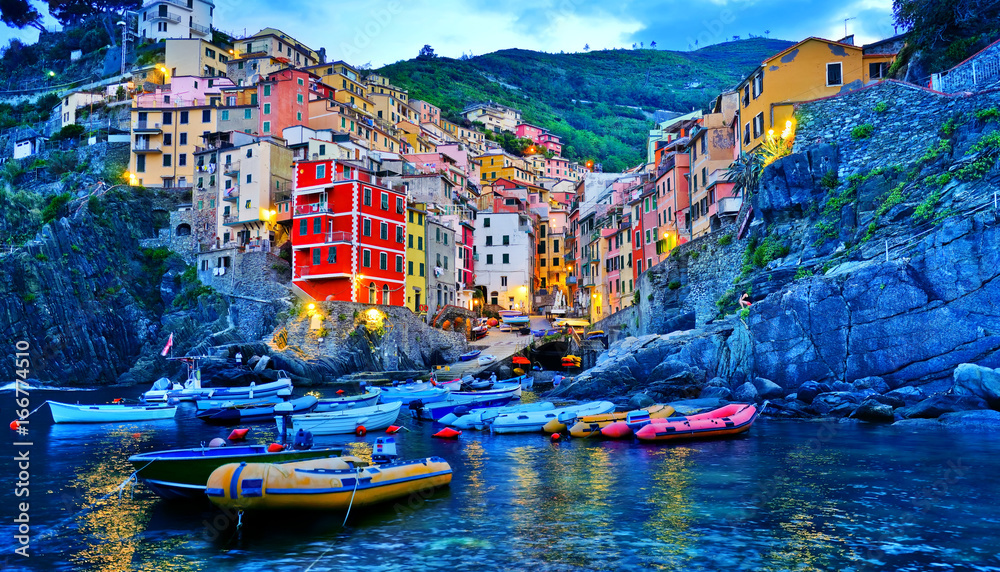 Riomaggiore village along the coastline of Cinque Terre area at dawn in Italy.