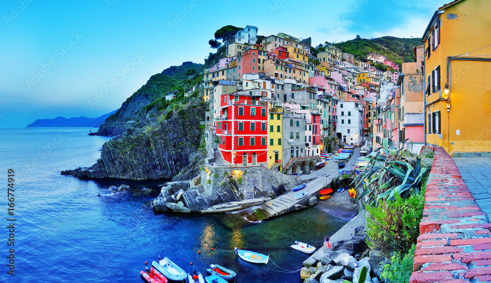 Riomaggiore village along the coastline of Cinque Terre area at dawn in Italy.