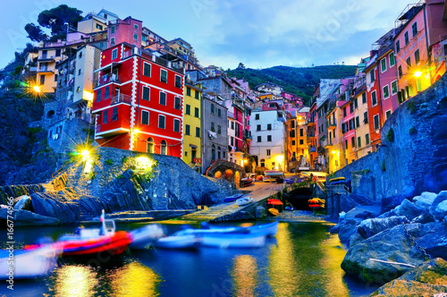 Riomaggiore village along the coastline of Cinque Terre area at dawn in Italy. photo