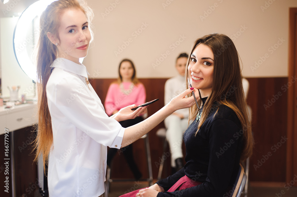 make up artist doing professional make up of young woman make up artist doing professional make up of young woman