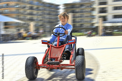 Young boy driving a Quadricycle