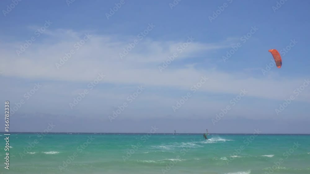 Kitesurfing and Windsurfing in a Windy Bay in Sardinia Italy Kitesurfing and Windsurfing in a Windy Bay in Sardinia Italy