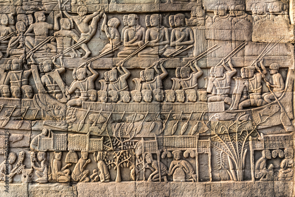 Obraz premium Bas-relief Sculpture at Bayon temple in Angkor Thom, Siemreap, Cambodia. Angkor Thom is a popular tourist attraction.