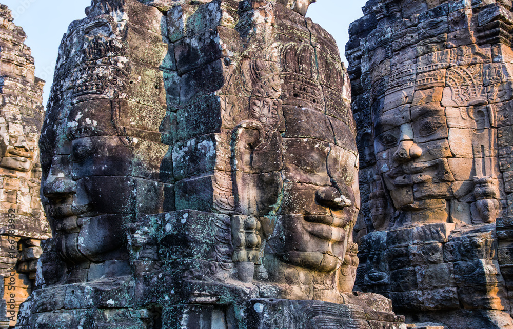 Stone murals and statue Bayon Temple Angkor Thom. Angkor Wat the largest religious monument in the world. Ancient Khmer architecture. Location: Siem Reap, Cambodia. Stone murals and statue Bayon Temple Angkor Thom. Angkor Wat the largest religious monument in the world. Ancient Khmer architecture. Location: Siem Reap, Cambodia.