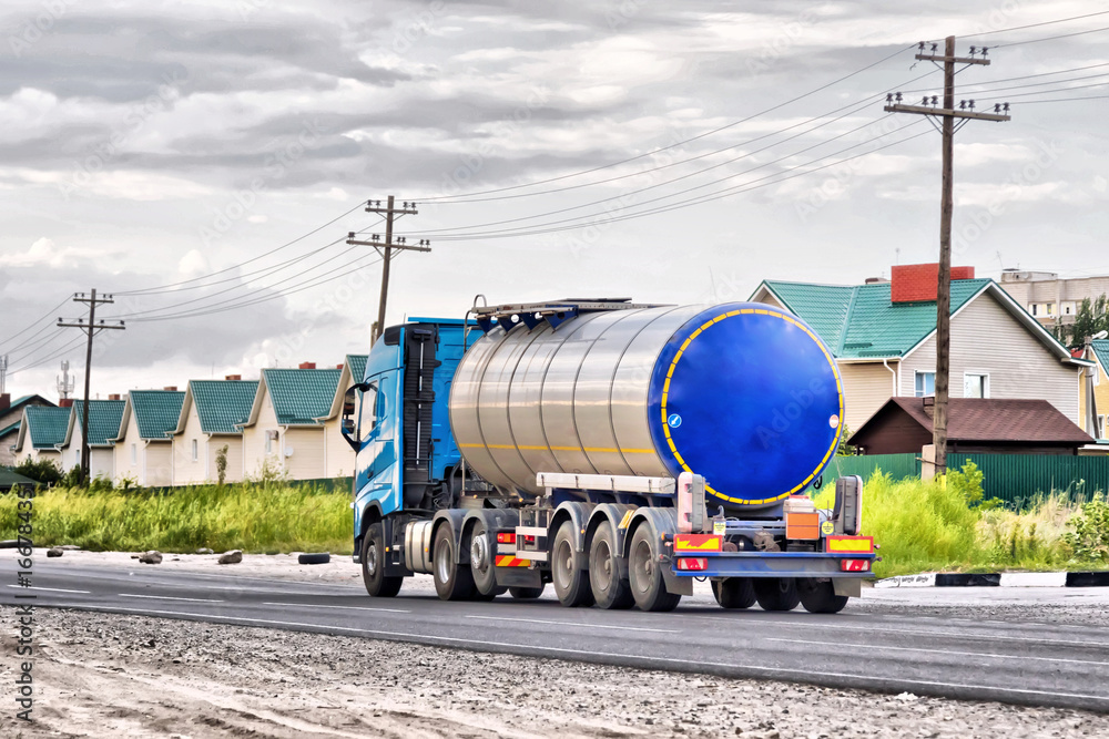 Lorry with chrome tanker on a large paved road Lorry with chrome tanker on a large paved road