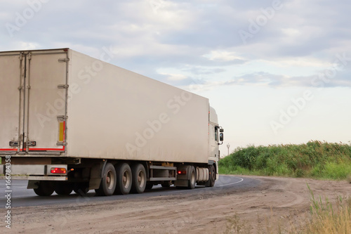  white lorry with white trailer over blue sky on the road © berkut_34