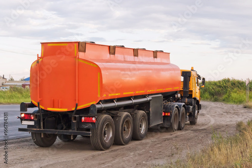 Lorry with orange tanker on parked on the roadside