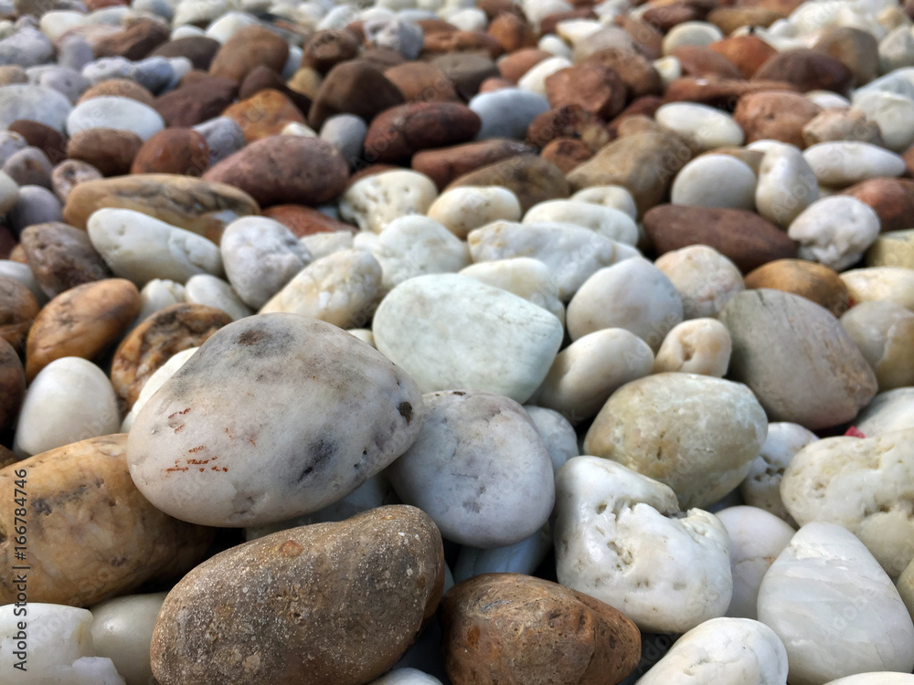 Smooth brown, black, gray, white pebbles or stones for use decor and garden landscaping. Its a small stone made smooth and round for decoration. Smooth brown, black, gray, white pebbles or stones for use decor and garden landscaping. Its a small stone made smooth and round for decoration.