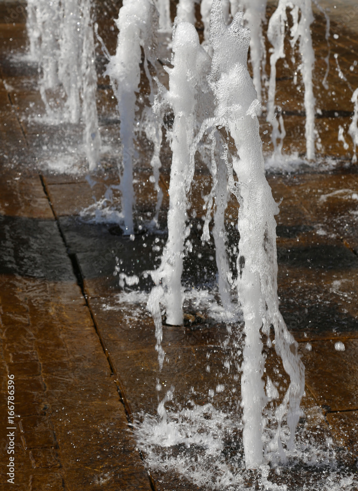 white foamy spray water of fountain in summer in a city white foamy spray water of fountain in summer in a city