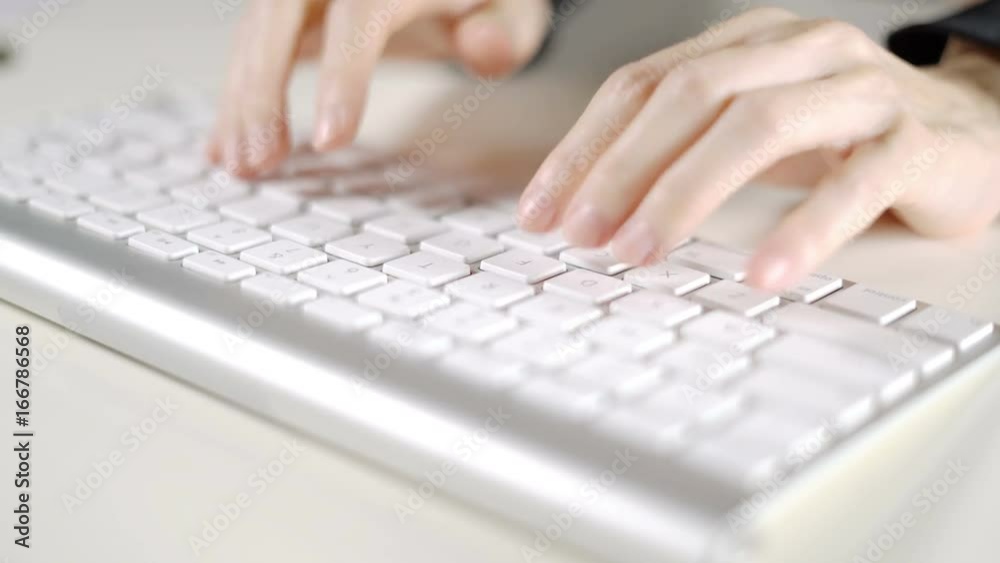 Secretary woman working in office with computer keyboard on white desk. Secretary woman working in office with computer keyboard on white desk.