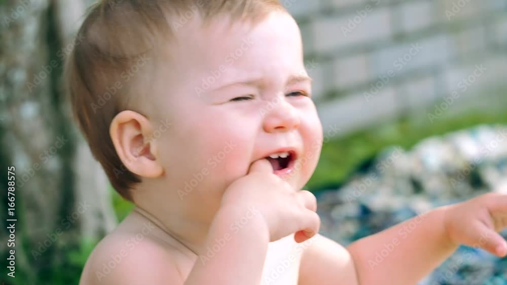 A cute little baby with blue eyes, first she is happy and then sad. A cute little baby with blue eyes, first she is happy and then sad.