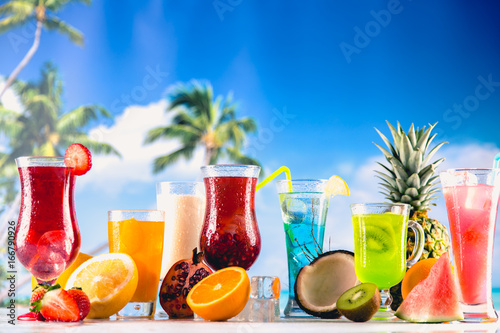 Set of exotic drinks on the beach with blue ocean background