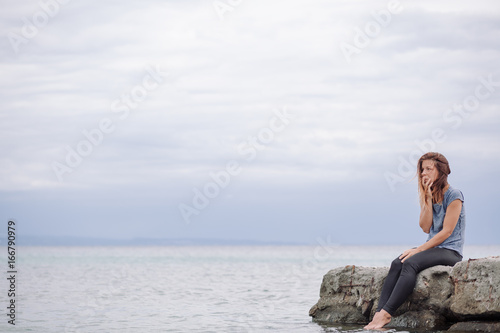 Woman alone and depressed at seaside © marjan4782