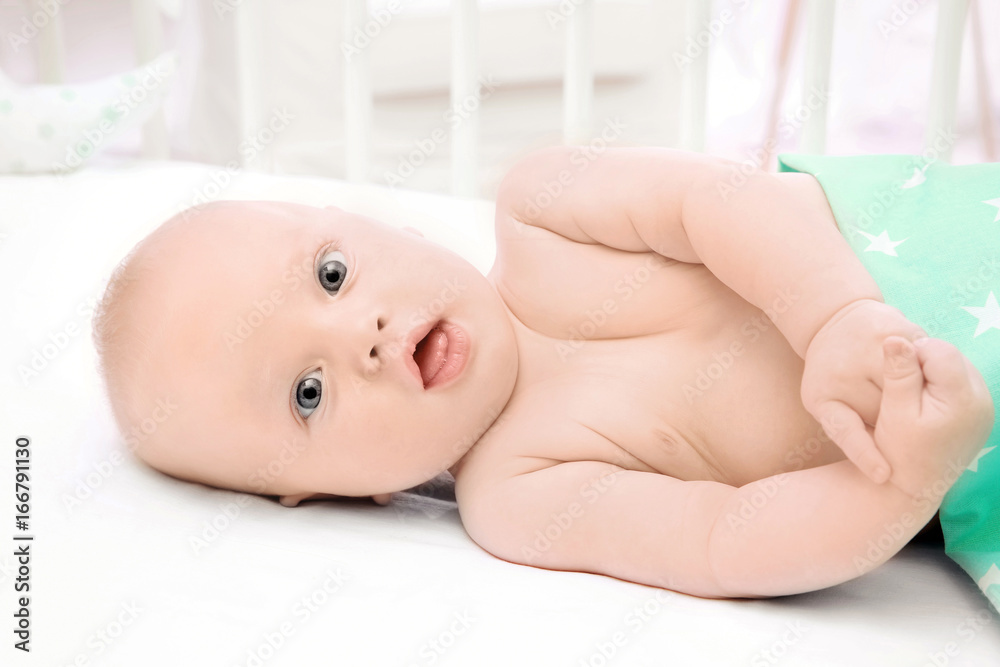 Emotional baby lying in cradle. Insomnia and sleep disorders concept