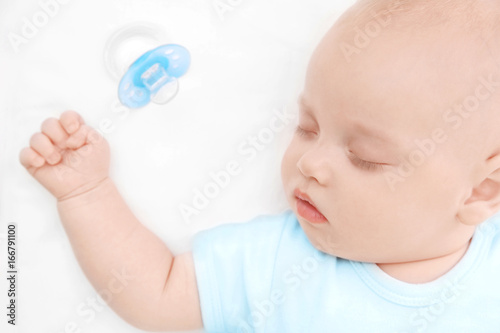 Adorable baby sleeping in c...