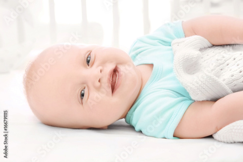 Emotional baby lying in cradle. Insomnia and sleep disorders concept