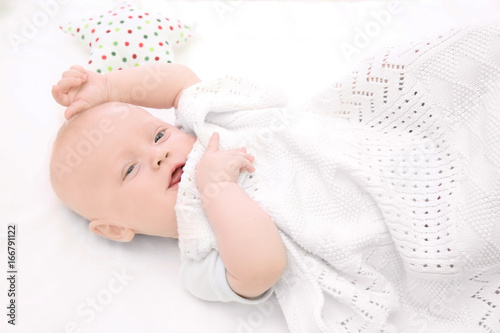 Emotional baby lying in cra...